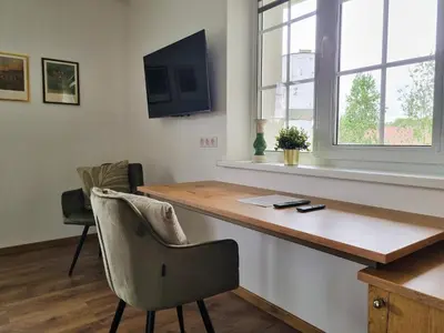 a home office with a desk and a chair at Kulpe Guest Rooms