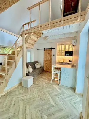 a loft apartment with a loft bed and a kitchen at Charming Cottage - Sauna - Central Location in Šiauliai