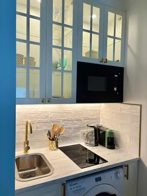 a kitchen with a sink and a microwave at Charming Cottage - Sauna - Central Location in Šiauliai