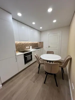 a kitchen with a table and chairs in a room at Skaidiškės Guesthouse in Skaidiškės