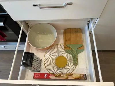 a drawer with a bowl and a fan in it at Skaidiškės Guesthouse in Skaidiškės