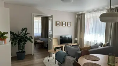 a living room with a couch and a tv at Maironis apartment - Cozy apartment in Raseiniai in Raseiniai
