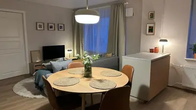 a living room with a table and a couch at Maironis apartment - Cozy apartment in Raseiniai in Raseiniai