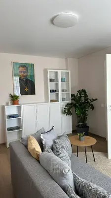 a living room with a couch and a table at Maironis apartment - Cozy apartment in Raseiniai in Raseiniai