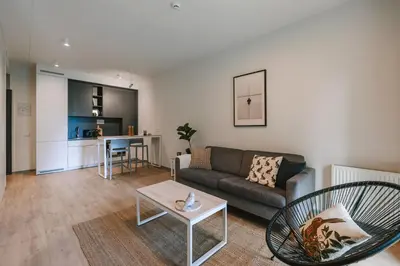 a living room with a couch and a table at Liv in Vilnius OZAS in Vilnius