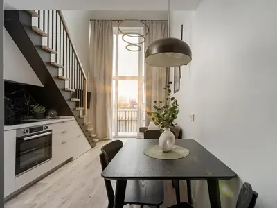 a kitchen with a table with a vase on it at Brand New Loft 61 in Pakopi