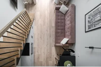 a staircase in a living room with wooden floors at Brand New Loft 61 in Pakopi