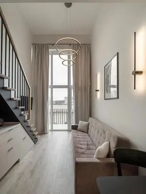 a living room with a couch and a chandelier at Brand New Loft 61 in Pakopi