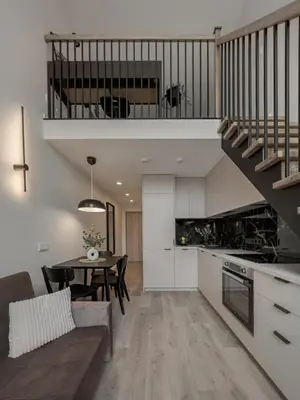 a kitchen and dining room with a staircase in a house at Brand New Loft 61 in Pakopi