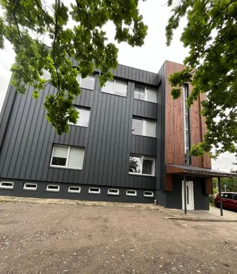 an office building with a black facade at Apartamentai 2 in Raseiniai