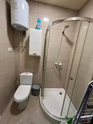 a small bathroom with a shower and a toilet at Apartamentai 2 in Raseiniai