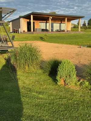 a house in the middle of a yard with grass at Harmony Resort & Spa in Padumble