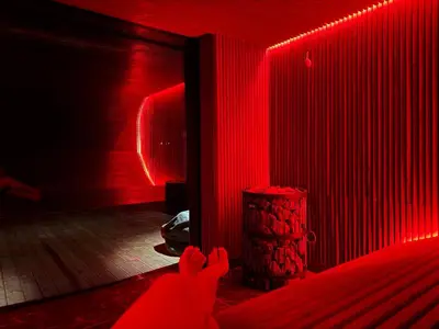 a red room with a person laying on the floor at Harmony Resort & Spa in Padumble