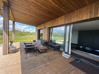 a living room with a large flat screen tv on a deck at Harmony Resort & Spa in Padumble