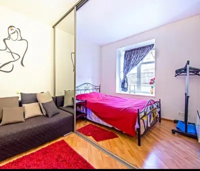 a living room with a couch and a mirror at Best location Old Town Choise in Vilnius