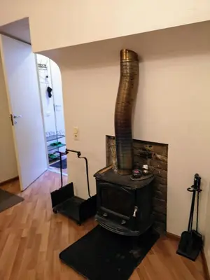 a fireplace in a living room with a stove at Best location Old Town Choise in Vilnius