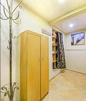 a room with a wooden cabinet and a walk in closet at Best location Old Town Choise in Vilnius