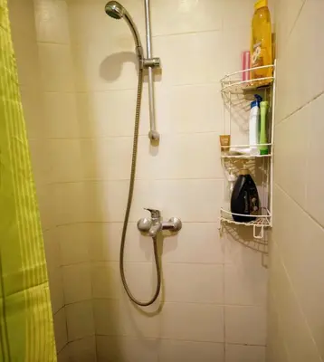 a shower with a shower head in a bathroom at Best location Old Town Choise in Vilnius