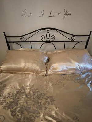 a bed with two pillows and a sign that says love you at Best location Old Town Choise in Vilnius