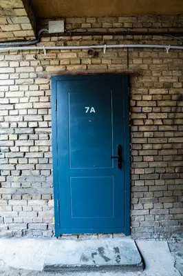 a blue door in a brick wall at Riverside Vilnius in Vilnius