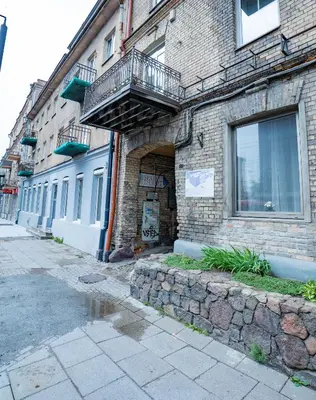 a brick building with a balcony on the side of it at Riverside Vilnius in Vilnius