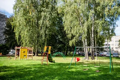 a park with playground equipment in the grass at Urban escape Kaunas - One bedroom apartment Krėvės 16 in Kaunas