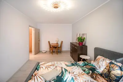 a bedroom with a bed and a table in it at Urban escape Kaunas - One bedroom apartment Krėvės 16 in Kaunas