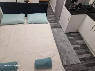 a bed with two pillows on it in a kitchen at RentA Citywalk Flat in Kaunas