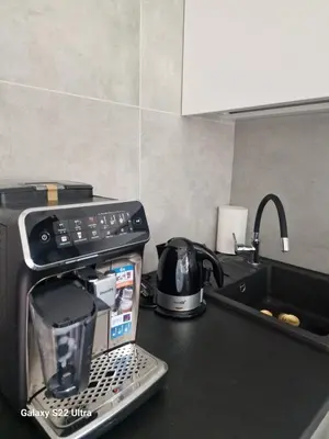 a kitchen counter with a coffee maker and a tea kettle at RentA Citywalk Flat in Kaunas