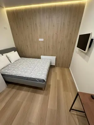 a small bedroom with a bed and a tv at 12 New Airport Apartment in Pakopi