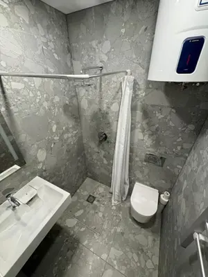 a bathroom with a sink and a toilet at 12 New Airport Apartment in Pakopi