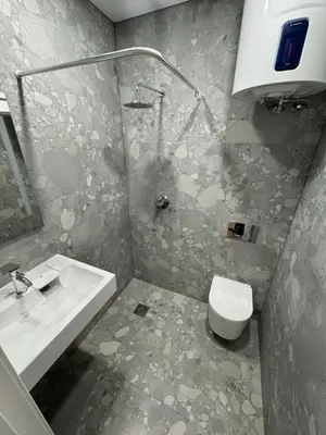 a bathroom with a toilet and a sink at 12 New Airport Apartment in Pakopi