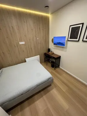 a bedroom with a bed and a table in it at 12 New Airport Apartment in Pakopi