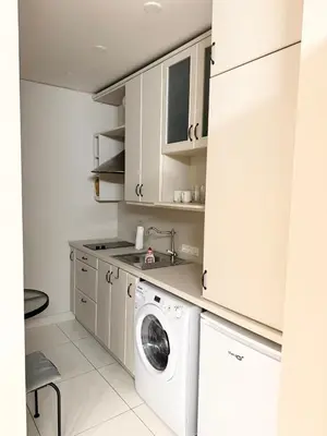 a white laundry room with a washer and dryer at Charming City-Center Apt I ᴄohost in Vilnius