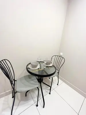 a black table with two chairs and wine glasses at Charming City-Center Apt I ᴄohost in Vilnius