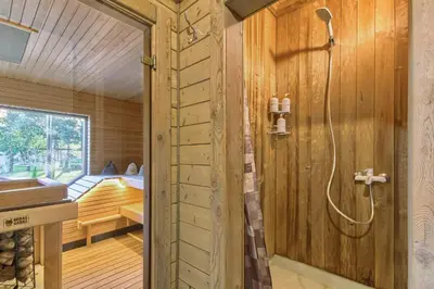 a sauna with a shower and a sink at Miško Kubilas in Randamonys