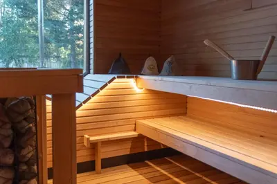 a sauna with a bench in a wooden room at Miško Kubilas in Randamonys