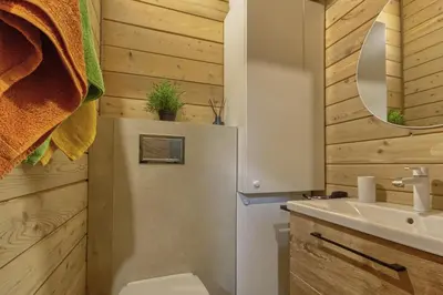 a bathroom with a refrigerator and a sink at Miško Kubilas in Randamonys