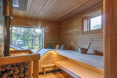 a sauna with wooden walls and a window at Miško Kubilas in Randamonys