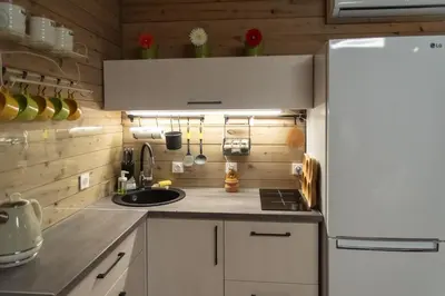 a kitchen with a white refrigerator and a sink at Miško Kubilas in Randamonys