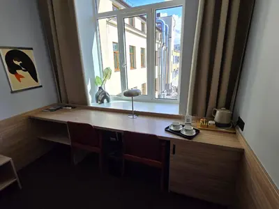 a desk in a room with a window at Private Hotel Room in the Corner of Vilnius City Centre in Vilnius