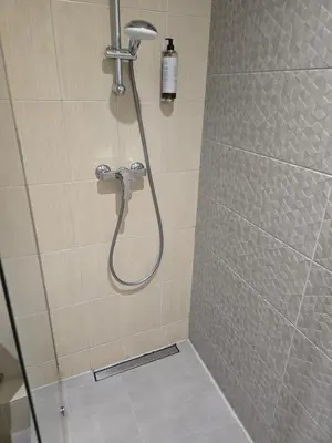 a shower with a shower head in a bathroom at Private Hotel Room in the Corner of Vilnius City Centre in Vilnius