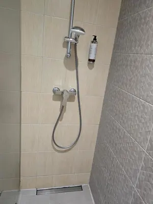 a shower with a shower head in a bathroom at Private Hotel Room in the Corner of Vilnius City Centre in Vilnius