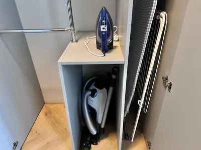 a small white table with a vacuum cleaner on it at Old Town Whispers in Kaunas
