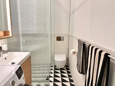 a small bathroom with a toilet and a sink at Old Town Whispers in Kaunas