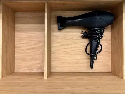 a black blow dryer in a wooden box at Old Town Whispers in Kaunas