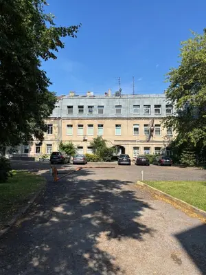 a large building with cars parked in a parking lot at Old Town Whispers in Kaunas