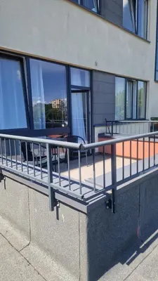 a metal railing on the side of a building at Apartamentai Vilnius Lazdynėliai in Vilnius