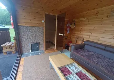 a living room with a couch and a fireplace at Kabakėlio slėnis in Kabakelis
