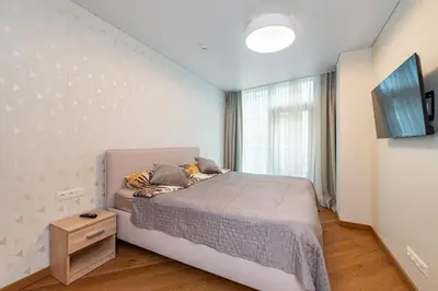 a small bedroom with a bed and a window at Sun Sonata Apartments 3 in Druskininkai